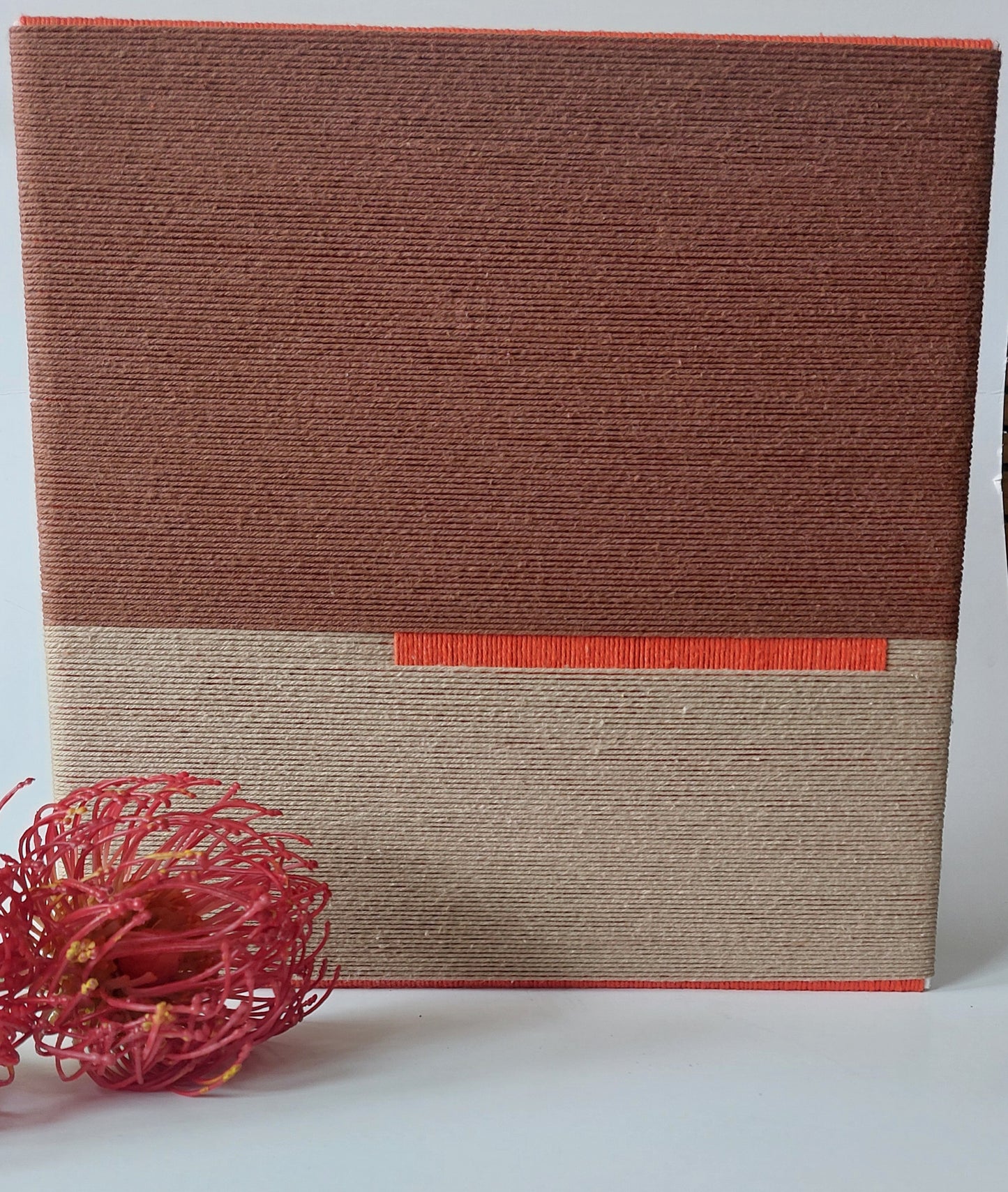 Close up of textile art in autumn colours.
