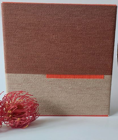 Close up of textile art in autumn colours.