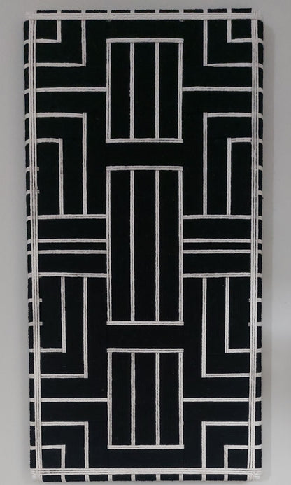 Black and cream modern textile wall art on a gray background